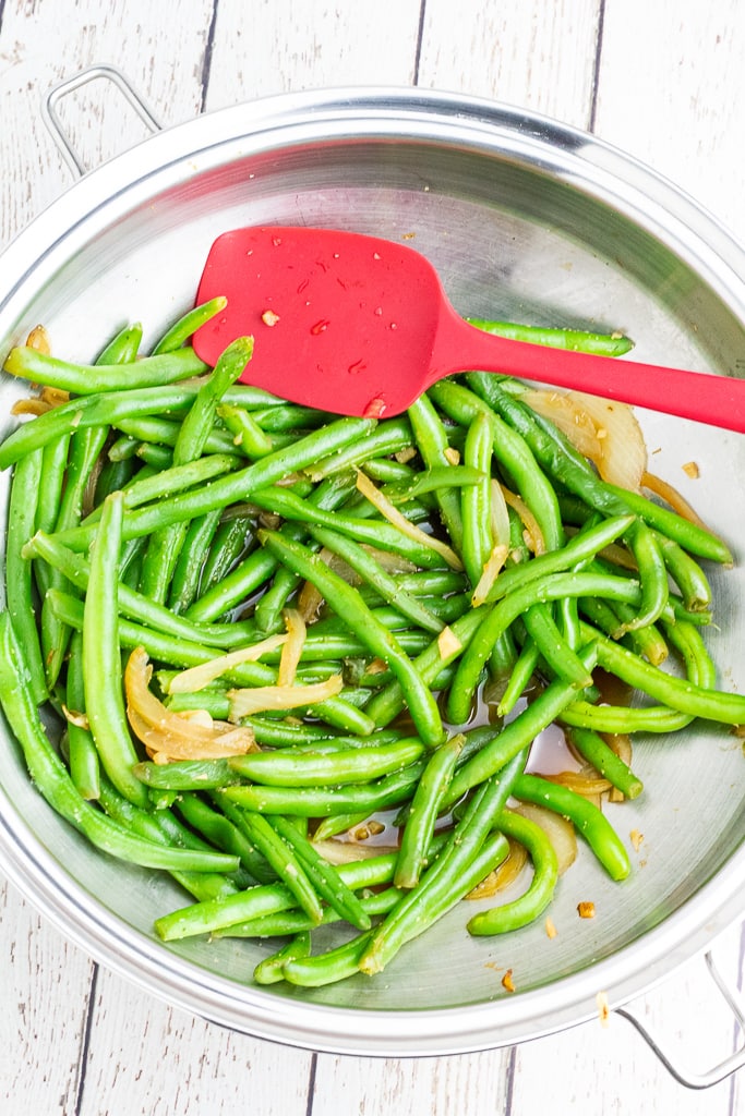stainless wok with green beans and onions