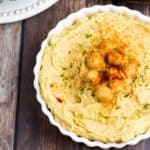 oil free hummus in white bowl on wood table