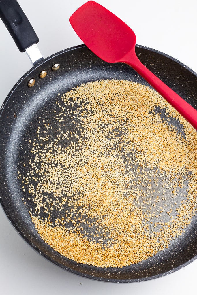 sesame seeds browning in frying pan