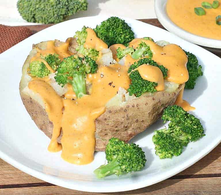 Vegan cashew cheese sauce on a baked potato with broccoli