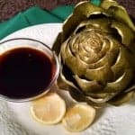 steamed artichoke with sauce and lemon