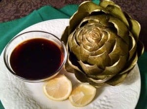 steamed artichoke with sauce and lemon