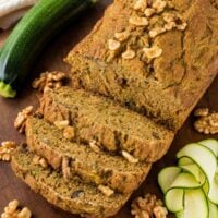 zucchini bread sliced on a wooden table.