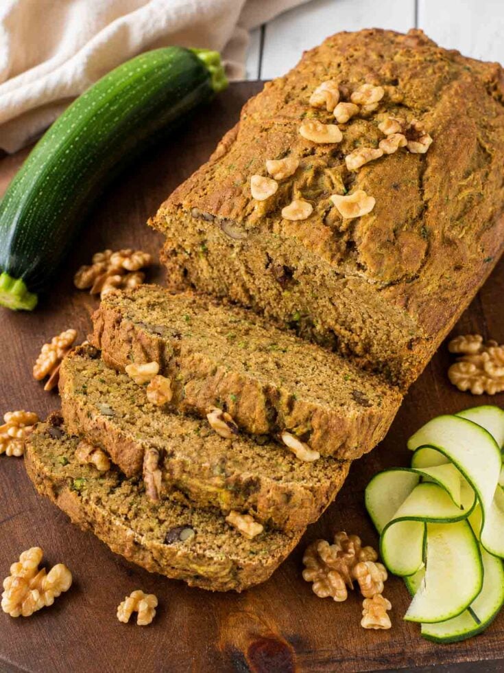 zucchini bread sliced on a wooden table.