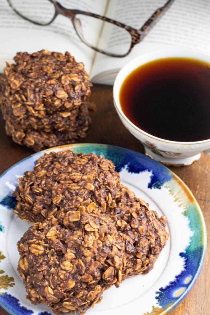 chocolate oatmeal cookies on plate with cup of coffee