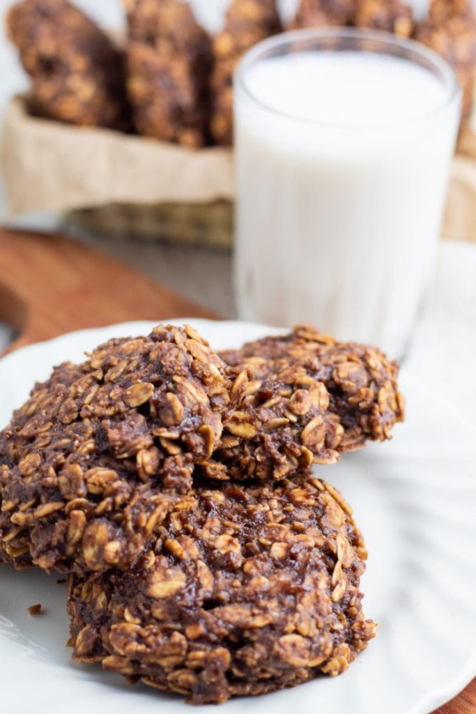 vegan oatmeal cookies on white plate with almond milk