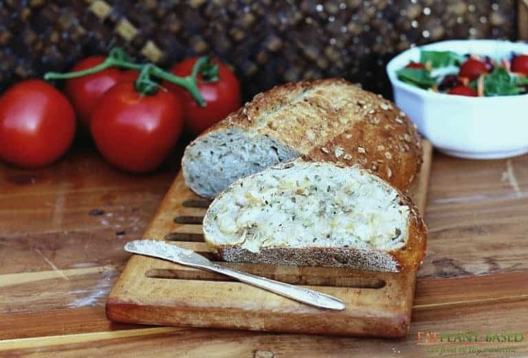 garlic butter on slice of bread on cutting board