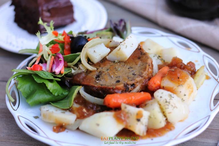 Mushroom roast served with potatoes, carrots, and onions.