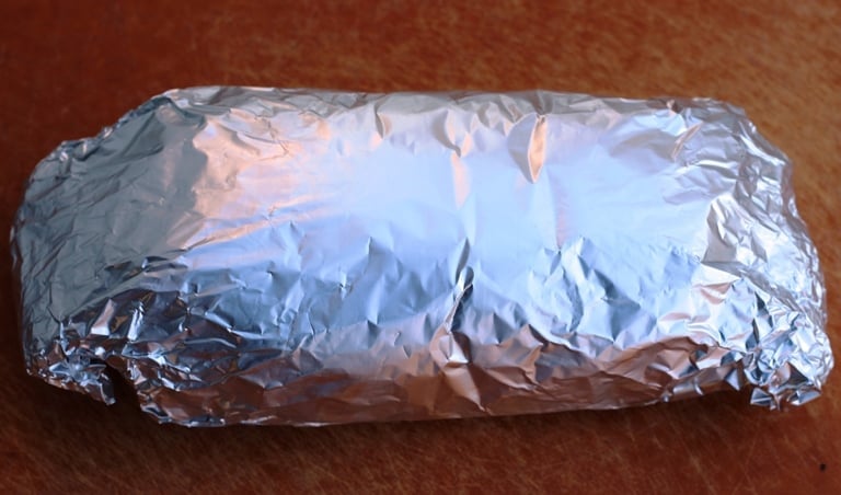 Mushroom loaf wrapped in parchement paper then foil for baking.