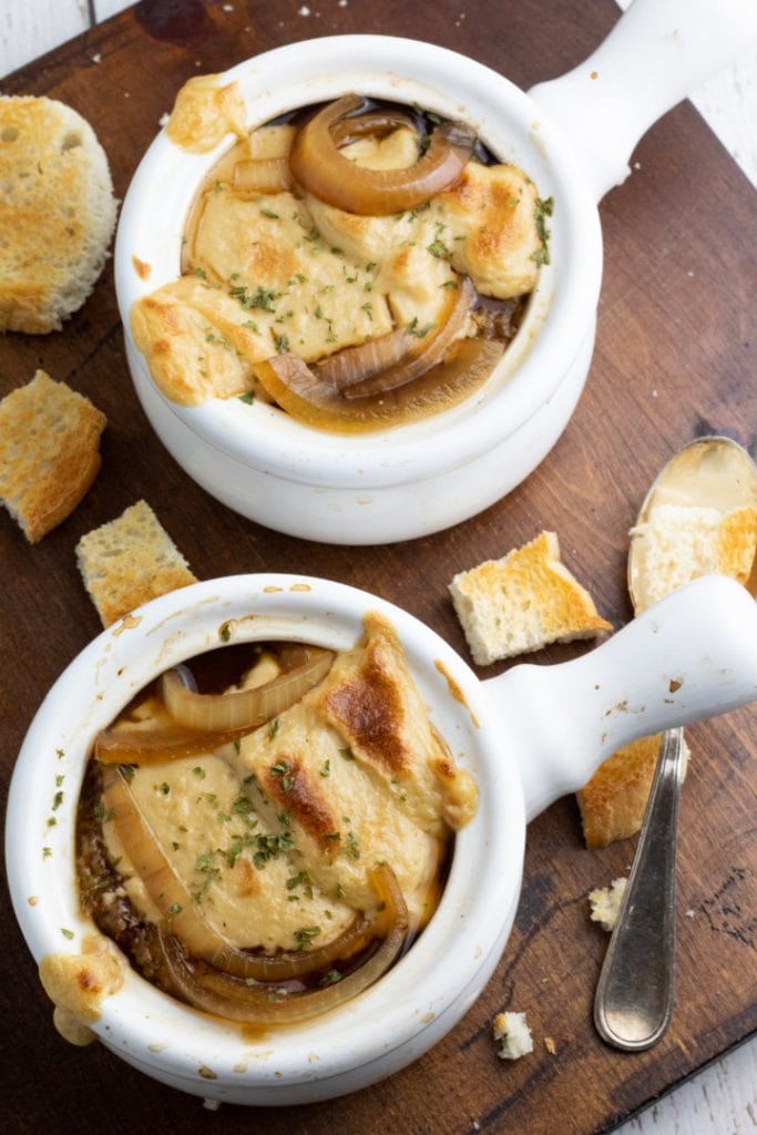 overhead shot of french onion soup in 2 soup crock bowls