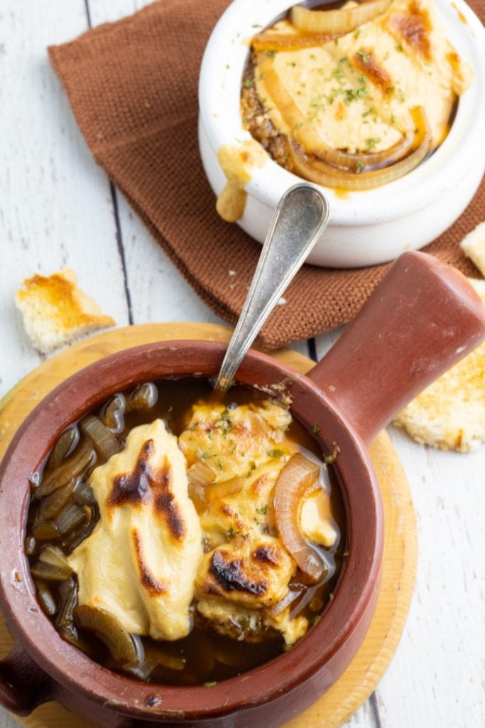 french onion soup in brown crock bowl and white bowl