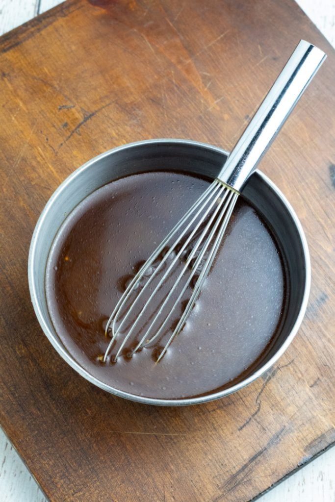 stir fry sauce in stainless mixing bowl with whisk