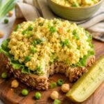 vegan egg salad on an open face sandwich on whole grain bread.