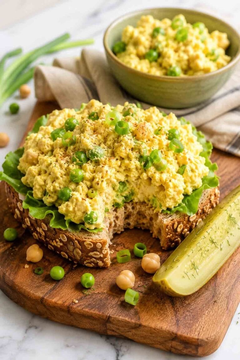 vegan egg salad on an open face sandwich on whole grain bread.