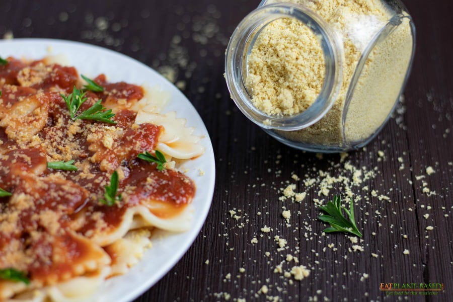 parmesan on wooden table with pasta