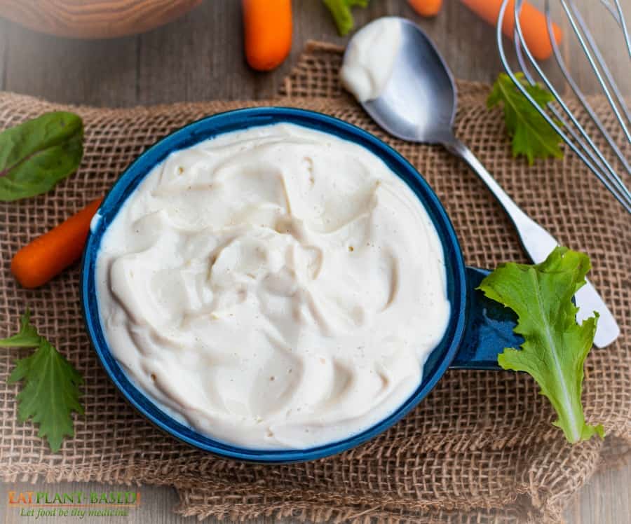 homemade vegan mayonnaise in blue bowl on burlap