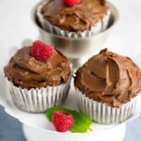 chocolate cupcakes with raspberries on pedestal