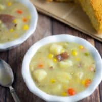 vegan pototo soup in white bowls with cornbread