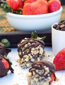 chocolate covered strawberries with nuts on white background