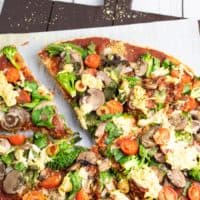 overhead photo of veggie pizza on cutting board