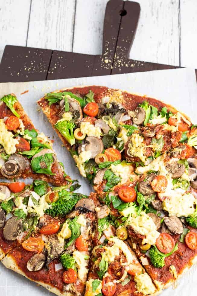 overhead photo of veggie pizza on cutting board