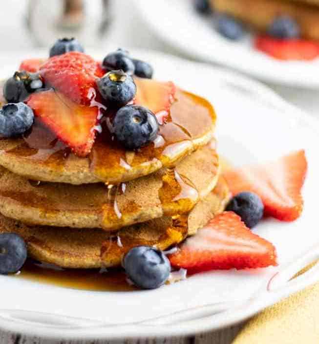 pancakes stacked with blueberries and strawberries