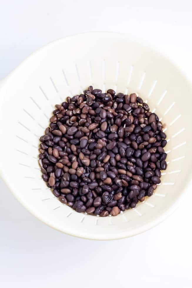 black beans in white colander