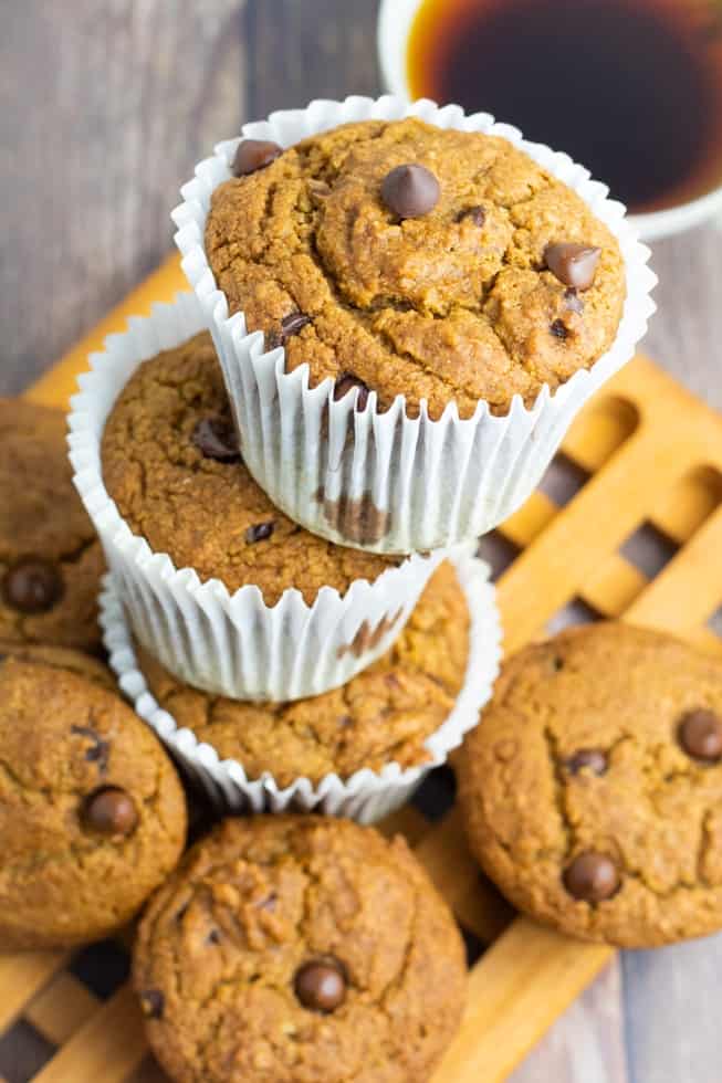 stacked chocolate chip muffins in white paper muffin cups