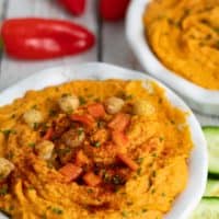 roasted red pepper hummus in white bowls