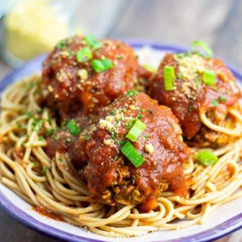 vegan spaghetti & meatballs in bowl on wooden table