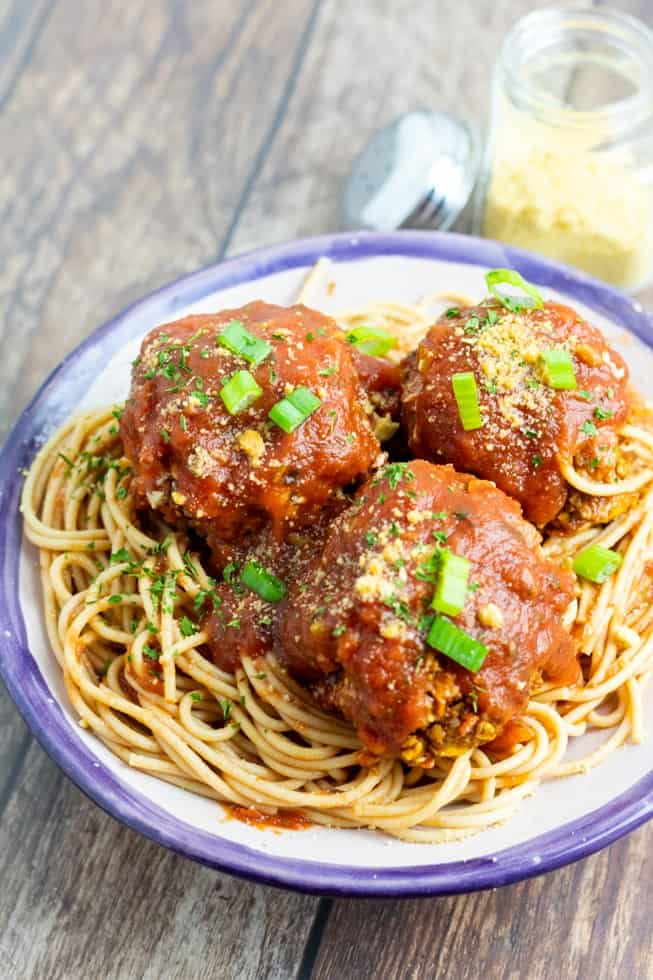 vegan spaghetti with meatballs in dish on wooden table