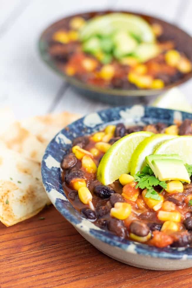vegan chili in bowl on wooden table