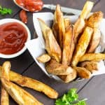 oil free french fries in basket with ketchup on wooden table
