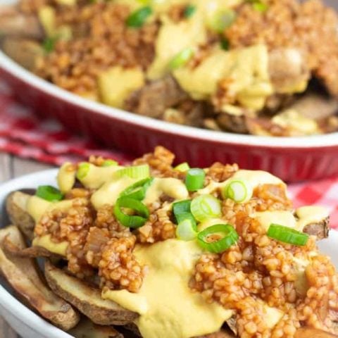 plate full of vegan chili cheese fries on wooden table