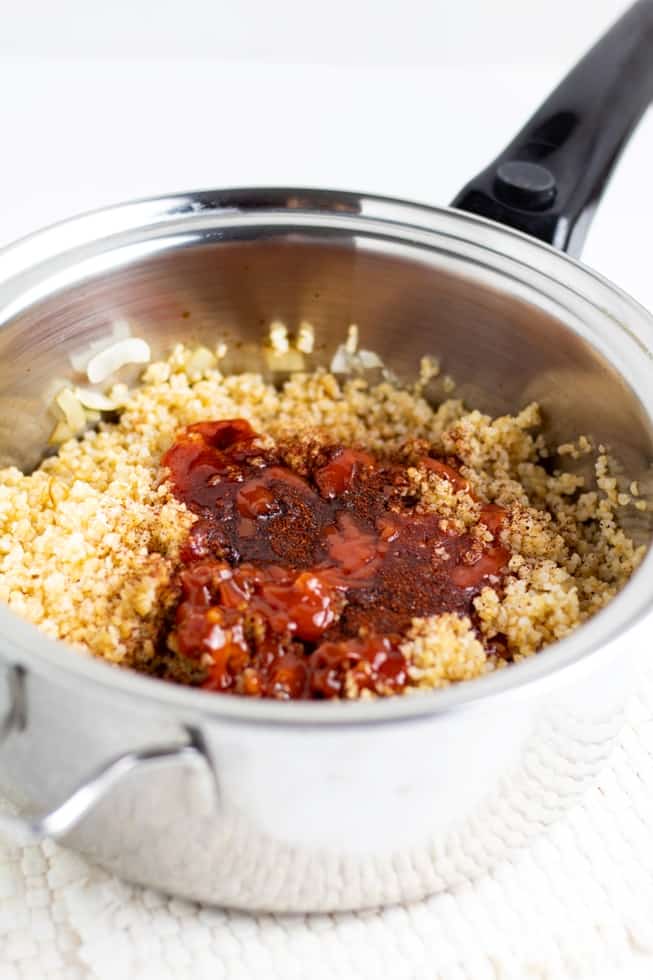 stainless pot with bulgur, onions, ketchup, chili spices