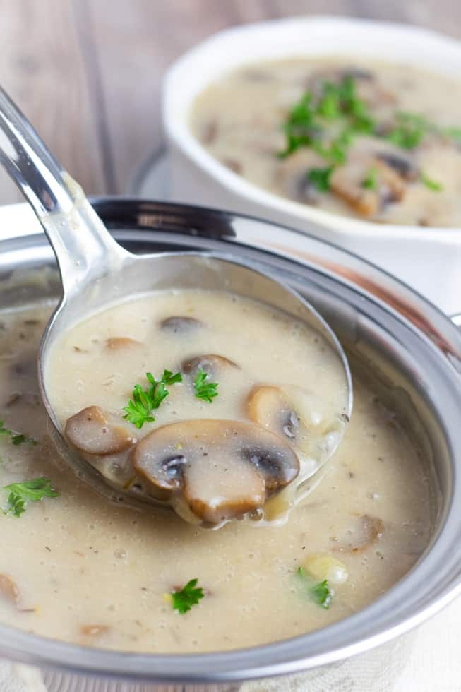 mushroom soup being ladled out of pot