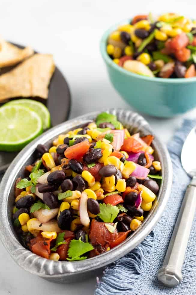 summer bean salad in stainless fancy bowl with silver spoon