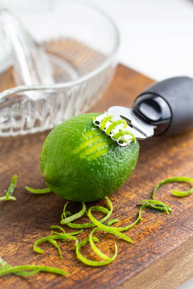 citrus zester being used on a lime