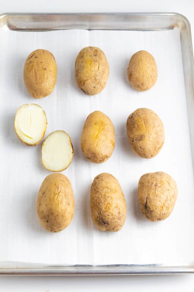 russett potatoes baked whole on baking sheet lined with parchment paper