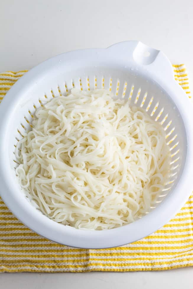 rice noodles draining in white colander
