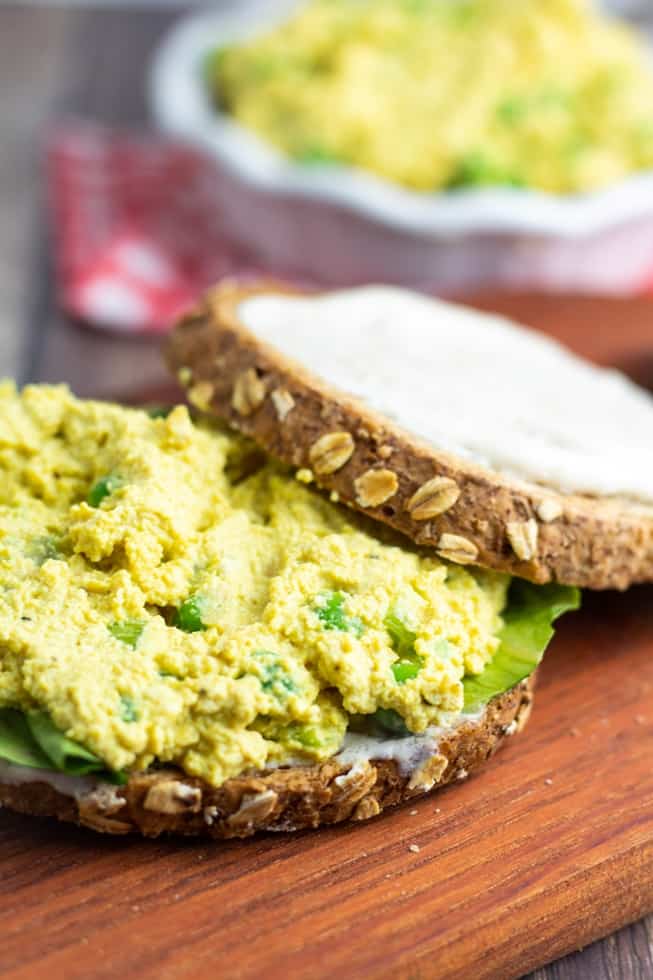 vegan egg salad on whole grain bread on cutting board