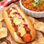 carrot dog topped with vegan bulgur chili and vegan cheese sauce.