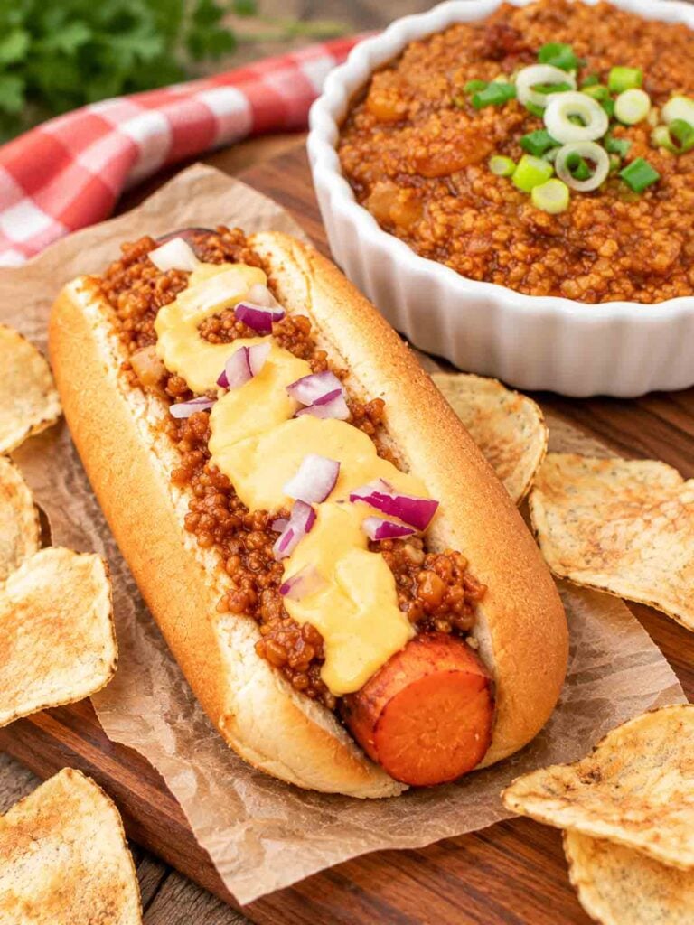 carrot dog topped with vegan bulgur chili and vegan cheese sauce.