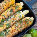 Mexican corn in black cast iron pan with lime wedge