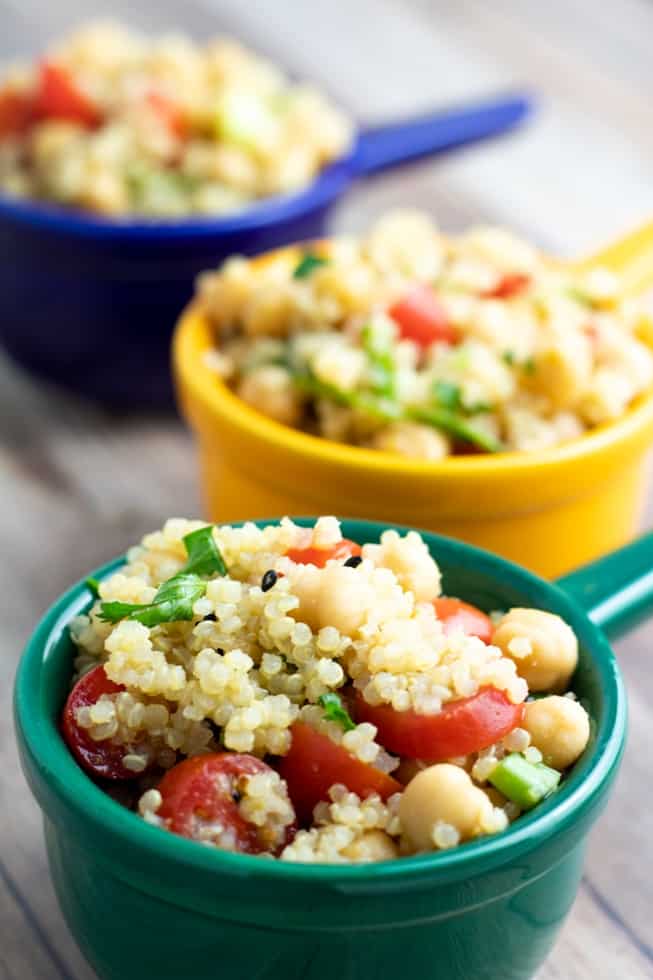 quinoa chickpea salad in 3 colorful bowls blue, green, yellow