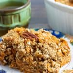 serving of sweet potato casserole on colorful plate with coffee cup in background