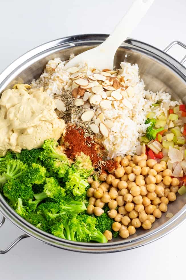 rice, broccoli, chickpeas, veggies, and vegan cheese sauce in pan