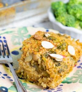 vegan broccoli casserole serving on colorful plate with casserole dish in background