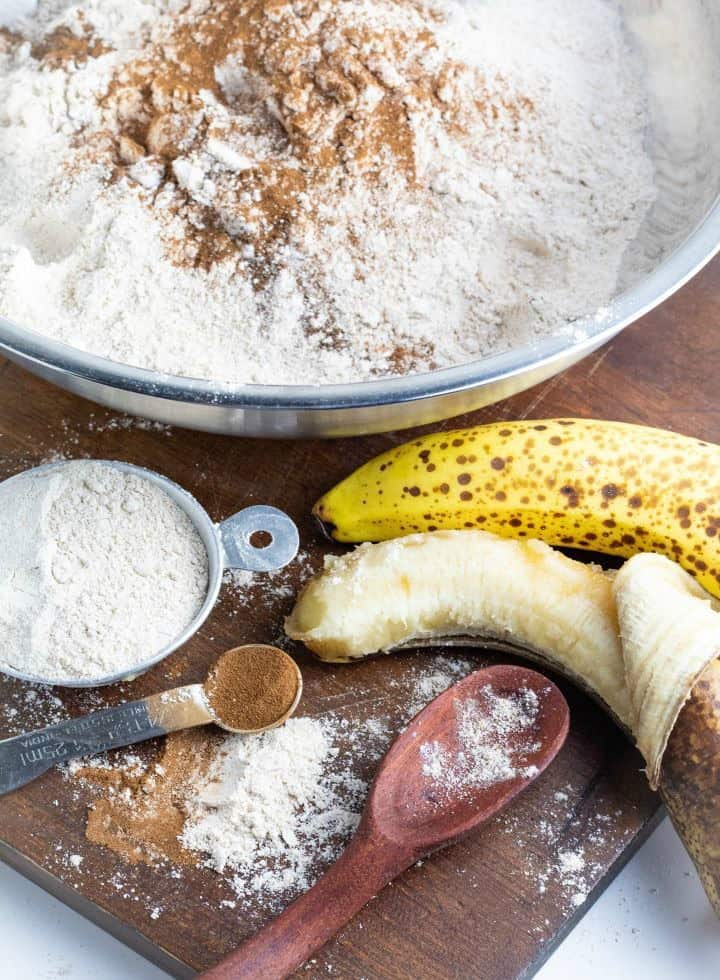 flour, cinnamon, spices, banana messy on wooden board