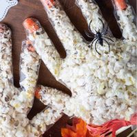 halloween popcorn hands with spider ring on one finger overhead shot